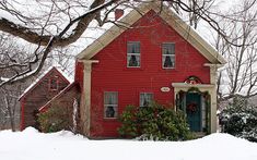 a red house in the middle of winter