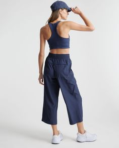 These look like classic work pants, but move like your favorite activewear. Our cropped Performance Tech Wide Leg Commuter Pants have just the right amount of stretch for days when you’re on the go, plus the sun protection and quick-dry properties of top-notch performance wear. And they look great with sneakers.  | Quince | Women's Performance Tech Wide Leg Pants in Navy, Size XS, Recycled Polyester Boyfriend Cardigan, Performance Leggings, Performance Wear, European Linens, Wide Leg Pant, Work Pants, Linen Pants, Spandex Fabric, Crop Tank