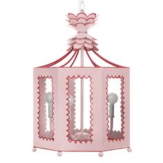 a pink birdcage hanging from the ceiling with scalloped trimmings