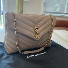 Brand New Ysl Saint Laurent Shoulder Bag In Overstitched Y-Quilted Leather - Sleek, Leather Bag Perfect For Everyday Chain And Leather Shoulder Straps; 19.29" Drop Unfolded, 9.84" Drop Folded Can Be Worn Doubled On The Shoulder Envelope Flap With Ysl Logo; Snap Closure Bronze Metal Hardware Zip Pocket Divides Interior; One Zip And One Slip Pocket Fabric Lining 8.6"H X 12"W X 4.7"D Approx. Weight 2.1 Lb. Made In Italy Luxury Taupe Evening Bag, Designer Taupe Evening Bags, Lux Purse, Ysl Lou Camera Bag, Taupe Outfit, Ysl Purse, Ysl Handbags, Kate Bags, Ysl Saint Laurent