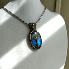 Discover the beauty of our unique Tree of Life pendant, meticulously handcrafted with care and attention to detail. This enchanting necklace features a stunning blue Labradorite stone, elegantly wrapped in German silver wire with a brass Tree of Life design. **What Makes This Pendant Special - **Handmade Craftsmanship Each pendant is entirely handcrafted, ensuring a one-of-a-kind piece. - **Spiritual Symbolism The Tree of Life design symbolizes growth, strength, and connection, making it a meaningful gift. - **Quality Materials Made with German silver wire and brass, paired with a striking blue Labradorite stone known for its mystical and protective qualities. - **Versatile Style The pendant comes with a steel chain, making it a versatile addition to any jewelry collection. **Product Detai Nickel Free Labradorite Jewelry As Gift, Nickel Free Labradorite Jewelry For Gift, Nickel-free Labradorite Jewelry As Gift, Unique Sapphire Necklace For Gift, Unique Sapphire Necklace As Gift, Blue Engraved Necklace For Keepsake, Blue Engraved Necklace For Gift, Sapphire Spiritual Necklace For Gift, Spiritual Sapphire Necklace For Gift