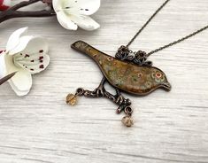 Glass mosaic bird pendant necklace, unique Autumn jewellery handmade in Britain, a perfect gift for women. Big bold necklace, Secret Santa gift UK. This piece is a lovely copper tone bird inlaid with a mosaic of autumn tone glass flowers and finished in durable resin. It's set on a dainty bronze tone chain and fastens with a lobster clasp and extender chain. You can select the length from thew drop down menu. There are two  beads that catch the light hanging from the bottom of the necklace. I ha Round Pendant Necklace With Bird Design For Gift, Necklace With Round Pendant And Bird Design For Gifts, Whimsical Bird Design Jewelry For Gifts, Whimsical Bird Design Jewelry For Gift, Bird Design Round Pendant Jewelry For Gifts, Bird Design Round Pendant Jewelry Gift, Bird Design Round Pendant Jewelry As Gift, Gift Jewelry With Bird Design Round Pendant, Round Pendant Jewelry With Bird Design For Gift