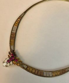 This stunning vintage sterling silver two toned collar necklace exemplifies elegant and sleek style and exquisite quality. Circa 1970s-80s, The collar has a yellow gold vermeil wash on it giving it a beautiful rich appearance. It weighs approximately 18.4 g. The necklace lays beautifully when worn and at the center are ruby colored stones which are probably synthetic or crystal. The Elegant necklace could be worn with the finest of jewelry or with your costume and casual pieces as well. The neck Luxury Vintage Multicolor Necklaces, Luxury Vintage Inlay Necklaces, Vintage Multi-strand Layered Metal Necklace, Casual Pieces, Vintage Gold-tone Multi-strand Necklaces, Vintage Multi-strand Metal Necklace, Decatur Ga, Colored Stones, Sleek Style