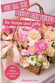 a basket filled with pink flowers sitting on top of a white table next to a sign that says see all the pretty pink things for home and gifts