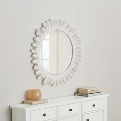 a white dresser and mirror in a room