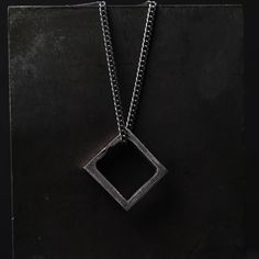 Square Pendant Necklace The square can represent basics, structure, and balance. The square will symbolize community, integrity, direction, and being practical and elemental. Wear this necklace as an amulet for order and stability in your life. This square pendant is a rustic piece of design made of 100% sterling silver. Size and Fit: The pendant's size: 16 mm x 17 mm You can choose to purchase only the pendant or add an oxidized sterling silver chain to it. The Details This necklace is made in Modern Necklace With Box Chain And Square Pendant, Silver Symbolic Necklace With Square Pendant, Symbolic Silver Necklace With Square Pendant, Minimalist Silver Square Necklace, Minimalist Square Silver Necklace, Square Silver Sterling Silver Necklace, Square Sterling Silver Necklace In Silver, Square Sterling Silver Necklace, Square Pendant Jewelry With Box Chain