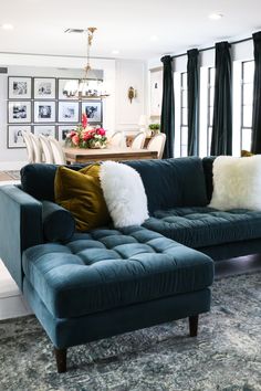 a living room filled with blue couches and pillows