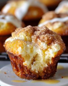 a close up of a muffin on a plate with other muffins in the background