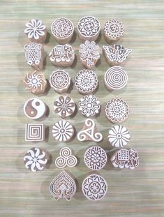 many different shapes and sizes of wooden stamps on a table with woodgrains in the background