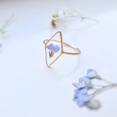 This handcrafted ring showcases real forget-me-not flowers preserved in clear resin, set in a durable brass frame. Lightweight and comfortable, it's perfect for everyday wear. A charming, nature-inspired piece, ideal for those who love floral, vintage, or boho jewellery. Available in silver or gold, it makes a thoughtful gift for special occasions like birthdays, anniversaries, or Mother's Day. This unique ring is a beautiful addition to any jewellery collection, combining natural beauty with ti Delicate Flower Ring As A Gift, Delicate Flower Ring As Gift, Delicate Flower Shaped Ring For Gift, Nature-inspired Rose Gold Flower Ring As Gift, Delicate Handmade Flower Ring As A Gift, Delicate Handmade Flower Ring For Gift, Delicate Flower-shaped Rings As Gifts, Handmade Delicate Flower Ring, Delicate Birth Flower Jewelry Ring