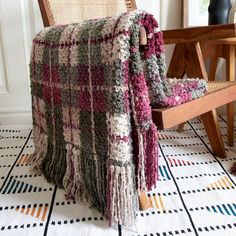 a blanket is draped over a chair on the floor