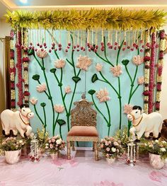 a decorated stage with flowers and animals on it