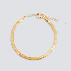 DESCRIPTION & DETAILS This dainty snake chain bracelet is glowing in rich gold, which gives a chic and delicate understated romantic look. A cute style to mix and match for your necklace layering or just on its own. Plating: 14k Gold Materials: 14K Gold on Stainless Steel Measurements: 16 + 5 cm extender Hypoallergenic SUSTAINABILITYIn-house plating - All pieces are hand crafted by our in-house jewellers ensuring a high standard of working conditions.Fair pricing - Due to our ethical manufacturi Trendy Gold Snake Shaped Jewelry, Adjustable Gold Snake Chain Bracelet, Gold Plated Snake Chain Bracelet, Gold Plated Adjustable Snake Chain Bracelet, Gold Snake Chain Bracelet For Gift, Gold Snake Chain Bracelet As Gift, Adjustable Tarnish Resistant Gold Snake Chain Bracelet, Adjustable Dainty Snake Chain Bracelet, Dainty Adjustable Snake Chain Bracelet