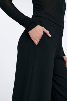 Claremont does all the legwork to keep your Monday-Sunday wardrobe polished. These relaxed wide-leg pants are fashioned from structured European ponte with a fly-front zipper and a wide waistband that rests comfortably at the mid-waist. Finished with functional pockets and a tuxedo panel to accentuate her clean lines. | Astrid, in black and in mist, is 5'9" (175 cm) tall, wearing size XS. Sejal, in black, is 5'8" (173 cm) tall, wearing size M. Approximately 39.5" (10.5 cm) from below the belt. Inseam is approximately 30" (76 cm). European Ponte, also known as Punto di Roma (60% Viscose, 30% Polyamide, 10% Lycra).Machine wash on delicate cycle, or hand wash in cold water. Tumble dry on low heat, or for best results, lay flat to dry. Designed in NYC. Handcrafted in Europe. | Marcella Claremo Sleek Wide-leg Pants For Spring, Formal Wide Leg Pants With Pockets, Elegant Wide Leg Culottes With Pockets, Black Straight Culottes For Formal Occasions, Fall Evening Wide Leg Pants With Pockets, High-waisted Wide Leg Pants For Evening With Pockets, High-waisted Wide Leg Pants With Pockets For Evening, Evening High-waisted Wide Leg Pants With Pockets, Sleek Wide Leg Spring Pants