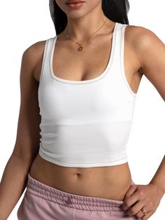 Crafted from a luxurious blend of 46% cotton, 46% rayon, and 8% spandex, this Cotton Rib Tank offers a soft touch and perfect stretch for all-day comfort. Featuring a square neck, fitted crop design, and chic contrast stitching, its double-layered breast area and removable pads provide ample support for bra-free wear. This versatile tank pairs seamlessly with yoga pants, shorts, skirts, jeans, and more, making it ideal for yoga, workouts, vacations, or casual wear. Transition easily from summer Crop Design, Square Neck Tank Top, Yoga Workouts, Skirts Jeans, Shorts Skirts, Square Neck, Yoga Pants, Casual Wear, Built In