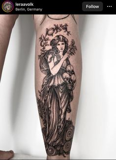 a person with a tattoo on their leg is holding a flower and an angel in her arms