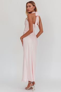 Our Blush Harmony Halter neck Maxi Dress is Type: Halter neck Front Twist Maxi Dress Color: Baby Pink Material: 100% Polyester Details: V neckline that beautifully frames the face Back neck bow tie for a stylish finish Open back design for a touch of allure Sleeveless style in luxurious satin fabric Imported Perfect for weddings and formal events, this dress will have you radiating elegance. Luxury Pink Satin Maxi Dress, Luxury Sleeveless Pink Satin Dress, Luxury Sleeveless Satin Finish Maxi Dress, Luxury Sleeveless Satin Dress With Tie Back, Luxury V-neck Satin Formal Dress, Luxury Sleeveless Dress With Back Opening, Pink Luxury Sleeveless Satin Dress, Luxury Blue Halter Maxi Dress, Luxury Blue Maxi Halter Dress