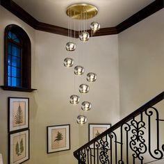 a chandelier hanging from the side of a stair case