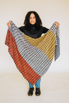 a woman is holding up a colorful blanket in front of her face and the words, gardena wrap crochet pattern