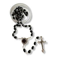 Discover a deeply spiritual treasure with this exquisite Saint Padre Pio black wooden rosary. Crafted with reverence and care, each bead is made from dark, lightweight wood that feels warm and comforting to the touch. The rosary's total length of 19 inches makes it both a substantial and portable item, perfect for prayer and meditation wherever you go. The centerpiece of this rosary is truly unique. It features a beautifully detailed image of Saint Padre Pio on the front, inviting a deep connect Black Spiritual Rosary Bracelet With Cross, Black Cross Rosary As Gift, Black Wooden Beads Rosary Spiritual Style, Black Wooden Beads Spiritual Rosary, Black Wooden Beads Rosary, Black Crucifix Rosary As Gift, Black Crucifix Rosary Bracelet As Gift, Wooden Rosary, Pope Benedict