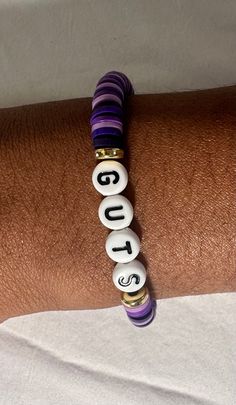 This bracelet inspired by Olivia Rodrigo's album GUTS, it's a pretty mix of dark purples with gold charms and GUTS letters. It is stretchy and durable, and fits all wrist sizes! Olivia Rodrigo Bracelet Guts, Casual Purple Stretch Bracelet For Everyday, Casual Everyday Purple Stretch Bracelet, Guts Bracelet Ideas, Guts Tour Bracelets, Guts Bracelet, Olivia Rodrigo Bracelet Ideas, Olivia Bracelet, Olivia Rodrigo Album