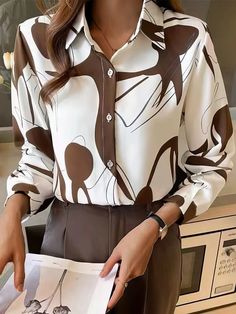 Long Sleeve Stand Collar Button Printed Blouse Upgrade your wardrobe with the MsDressly® Abstract Artist Printed Long Sleeve Button-Up Top. This stunning blouse is designed to captivate with its unique abstract print in brown, offering a blend of casual and fashion-forward style. Key Features: Long sleeves for added coverage and style Elegant stand collar for a refined look Chic button-up design for versatility Made from 100% polyester for a lightweight feel Easy care instructions: Hand wash col Trendy Button-up Blouse With Abstract Print, Trendy White Blouse With Abstract Print, Chic Graphic Print Button-up Blouse, Chic Button-up Blouse With Graphic Print, Fall Abstract Print Button-up Blouse, Elegant Graphic Print Blouse For Work, Elegant Graphic Print Workwear Blouse, Elegant Workwear Blouse With Graphic Print, Patterned Blouse With Button Closure For Work