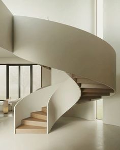 a white spiral staircase in a modern home