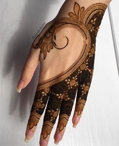 a woman's hand is decorated with hennap and intricate designs on it