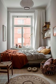 a bed sitting under a window in a bedroom