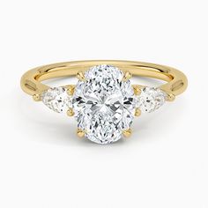 an oval cut diamond ring with three pear shaped diamonds