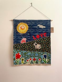 a wall hanging with an art piece on it