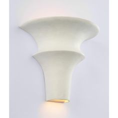 a white wall light that is on the side of a wall