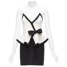 ALESSANDRA RICH black white graphic colorblocked peplum cocktail dress IT38 XS Reference: AAWC/A01089 Brand: Alessandra Rich Material: Virgin Wool Color: Black, White Pattern: Solid Closure: Zip Lining: Black Fabric Extra Details: White and black virgin wool two-tone strapless mini dress from Alessandra Rich featuring a bow detail, a peplum design skirt, a deep V neck, a fitted silhouette, an invisible back zip fastening, a short length and a straight hem. Made in: Italy CONDITION: Condition: Excellent, this item was pre-owned and is in excellent condition. This piece appears to be unworn and is in great condition. Comes with: Style code present (Generic) SIZING Designer size: IT38 Size reference: US0 / UK6 / IT38 / FR34 / XXS-XS MEASUREMENTS: Chest: 35cm / 13.7" Waist: 30cm / 11.7" Hip: 4 Peplum Design, Peplum Designs, Design Skirt, Zip Lining, Alessandra Rich, Strapless Mini Dress, Fitted Silhouette, Black Cocktail Dress, Bow Detail