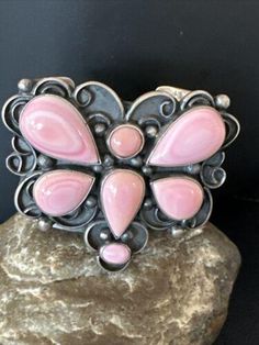 Masha Indian Native American Jewelry -On Route 66 - Albuquerque, New Mexico U.S.A Item Specifics           * Stone : Pink Conch Weight 129 gms * Gap 1" * Metal : Sterling Silver * Color : Pink * Jewelry Type : Bracelets * SKU : 15848 * Inner Circumference 5.80" * Gap 1" * Country of Origin : United States * Ethnic & Regional Style : Native American * Metal Puity : 925 Genuine Sterling Silver Jewelry This beautiful Bracelet is made from all 925 Sterling Silver. These pieces are painstakingly handmade by the artist creating the perfect balance of color and shine. Whether you are just starting out or are a serious collector you will not be disappointed with this work of art. Authenticity you can Trust We have been in this industry since 1972, all our Jewelry is Authentic Artisan Handcrafted S Pink Hand-set Sterling Silver Jewelry, Pink Nickel-free Bohemian Jewelry, Pink Bohemian Adjustable Cuff Bracelet, Artisan Nickel-free Pink Jewelry, Conch Cuff, Bohemian Pink Shell-shaped Jewelry, New Mexico Usa, Albuquerque New Mexico, Native American Artists