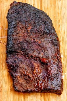 a piece of meat sitting on top of a wooden cutting board