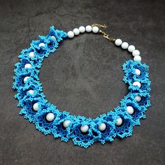 Add a touch of bohemian elegance to your ensemble with our handmade beaded lace necklace. Crafted with care, this stunning piece features intricate blue beadwork and accents of white agate beads. Finished with 18k gold-filled charms for a touch of luxury, it's a unique addition to any jewelry collection. Perfect for adding a pop of color to your outfit, this necklace is sure to turn heads wherever you go. Complete with a secure clasp and extender chain for the perfect fit, it's the quintessentia Bohemian Gemstone Beads For Wedding, Bohemian Wedding Beads, White Bohemian Beaded Necklaces With Bead Caps, Elegant Bead Cap Necklaces For Festivals, White Bohemian Beaded Necklace With Bead Caps, Elegant Festival Necklace With Bead Caps, Elegant Necklace With Bead Caps For Festivals, Blue Bohemian Beaded Necklaces With Bead Caps, Blue Bohemian Necklaces With Bead Caps