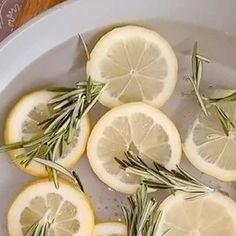 sliced lemons and rosemary in a white bowl