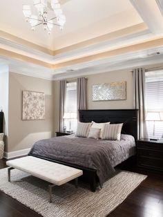 a bedroom with a large bed and two windows in the ceiling, along with a rug on the floor