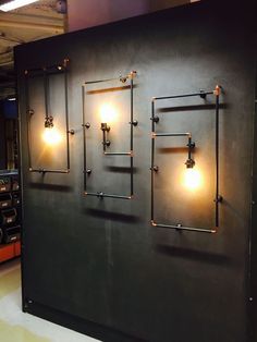 a large metal wall with three lights on it