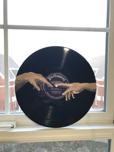 a black record sitting on top of a window sill