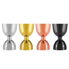 three different colored vases sitting next to each other on a white surface with one black, the other gold and silver