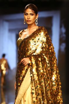 Gold saree with all-over sequin embroidery. Comes with sleeveless blouse and petticoat.
Component: 3
Pattern: Embroidery
Type Of Work: Sequin
Neckline: Sweetheart
Sleeve Type: Sleeveless
Fabric: Foil Georgette
Color: Gold
Other Details: 
Shoulder straps with sequin embroidery
Occasion: Wedding - Aza Fashions Gold Saree, Embroidered Saree, Gold Blouse, Sequin Embroidery, Luxury Sale, Pattern Embroidery, Blouse For Women, Sequins Embroidery, Buy Gold