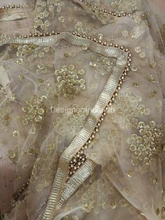 This is a Dupatta made on orders. It is made using golden color net fabric with gold sequine embroidery all over. We stitch a beautiful golden lace to all sides of it and decorate with tassels. Dupatta is having a length of 100 inches and width of around 40 inches. I don't keep it readymade I only make it exclusively for my customers. Can be fully customised. Floor-length Sequin Fabric For Diwali, Floor-length Gota Work Dupatta For Reception, Designer Gold Lehenga With Mirror Work, Gold Lehenga With Mirror Work For Designer Wear, Festive Gold Lehenga With Mirror Work, Traditional Sequined Anarkali Set For Receptions, Traditional Anarkali Set With Sequins For Reception, Gold Lehenga Saree With Mirror Work, Reception Anarkali Sharara With Sequins