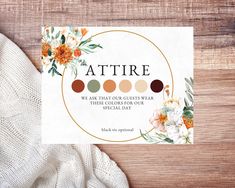 a card with the words attrie on it next to a white sweater and flowers