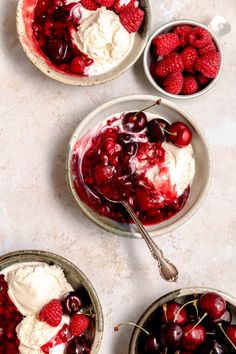 three bowls filled with ice cream and cherries on top of a white countertop