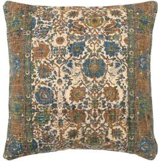 an antique rug pillow with blue, green and brown colors on the front cover is shown