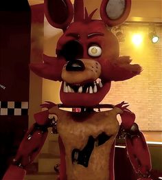 a creepy looking animal standing in a kitchen