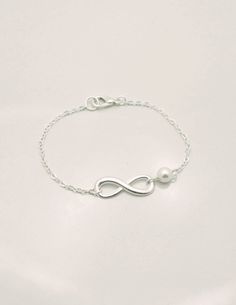 15% OFF ENTIRE ORDER - SALE ENDS TONIGHT This set of 3 bracelets is hand-crafted using sterling silver chain, 6mm Swarovski pearls and silver plated infinity charms. Infinity charm is also available in solid sterling silver. See 4th photo (sterling silver charm is smaller). Bracelet measures approximately 7 inches long** and secures with lobster clasp. Pearl available in white, ivory, light pink, light grey, dark grey, or one of each color. **IMPORTANT: Measures 7 inches long but can be made in Silver Infinity Bracelet With Adjustable Chain, Hypoallergenic Sterling Silver Infinity Jewelry, Hypoallergenic Infinity Sterling Silver Jewelry, Elegant Adjustable Sterling Silver Bracelet For Mother's Day, Sterling Silver Bracelet For Bridesmaids, White Sterling Silver Bracelets For Bridesmaids, White Sterling Silver Bracelet For Bridesmaid Gift, Nickel-free Silver Infinity Jewelry, Minimalist Silver Infinity Bracelet