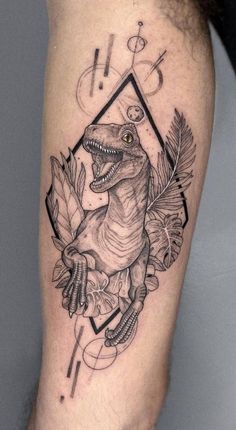 a black and white tattoo with an image of a dinosaur