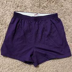 a pair of purple shorts laying on the floor